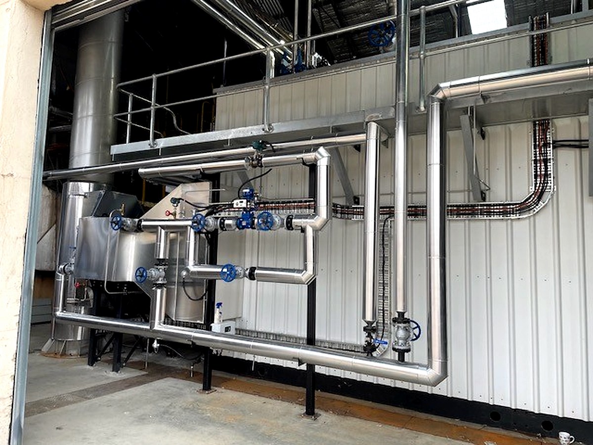 Sheet metal cladding on industrial process pipework in an open industrial plant area